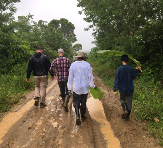 Origin trip visitors walking down a dirt road